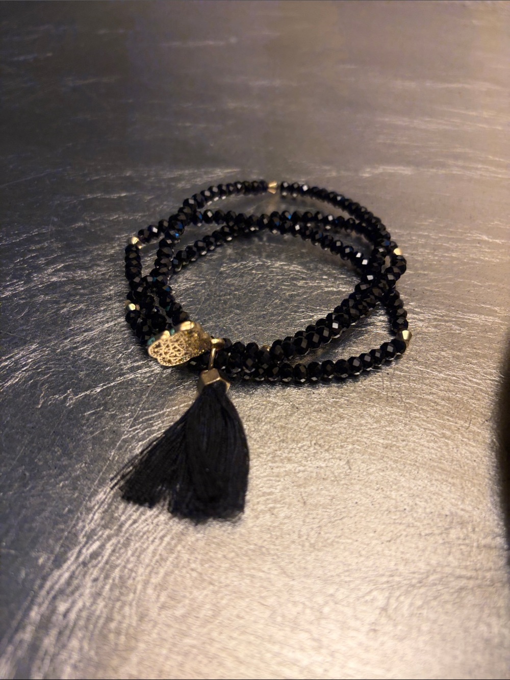 Kendra Scott multi strand (3) black crystal bracelet with filigree medallion.